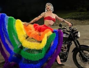 Violet Chachki on a motorcycle in a Pride grown