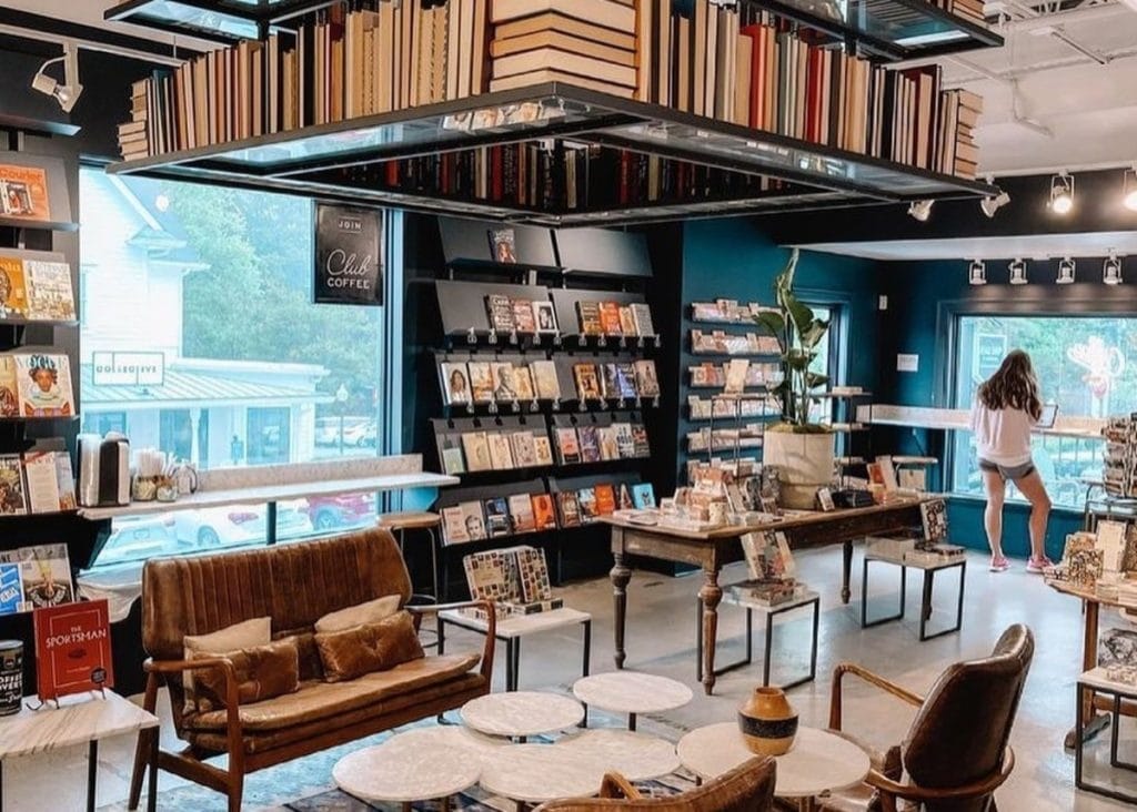 The interior of a bookstore/coffee shop with sofas and bookshelves.