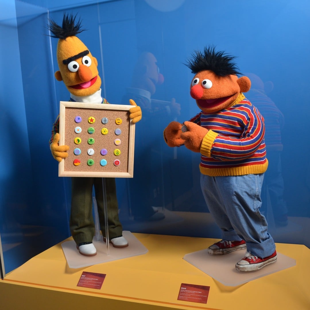 Two miniature versions of Bert and Ernie in a museum