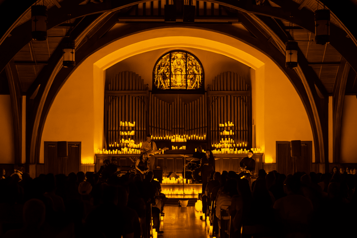 The altar inside the chapel lit up by candlelight as a string quartet performs.