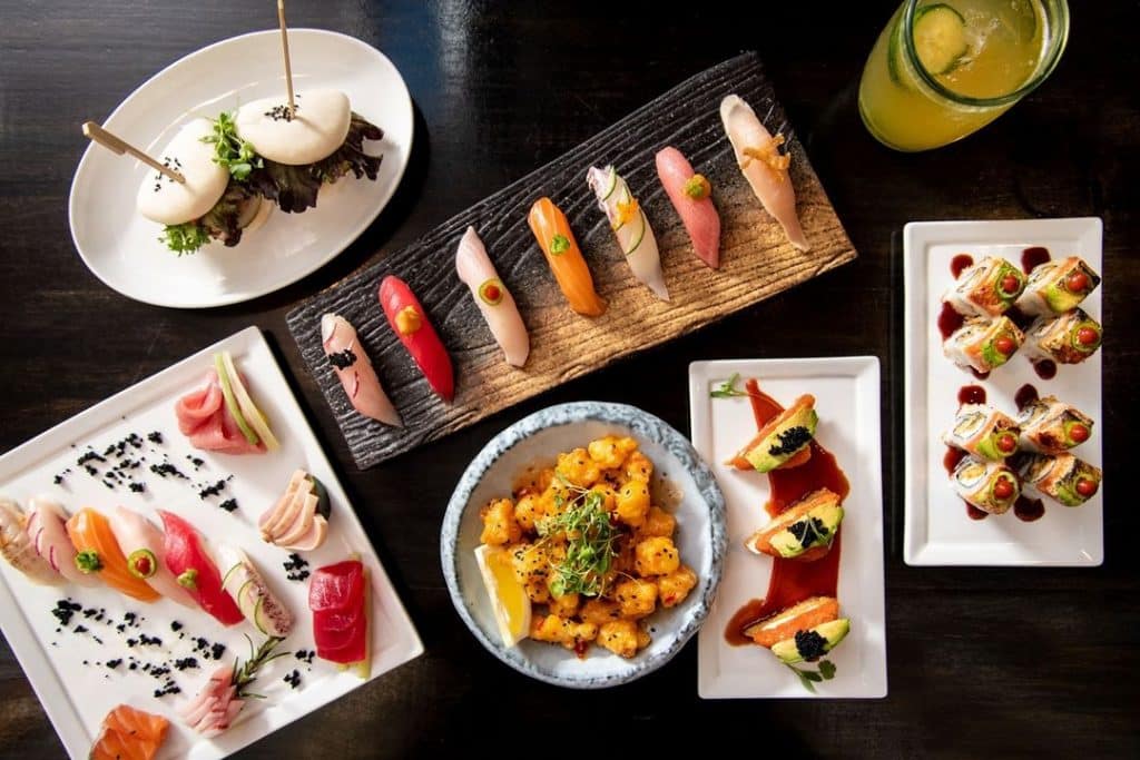 A selection of sushi dishes and a cocktail on display at Monkey 68's sushi in Atlanta.