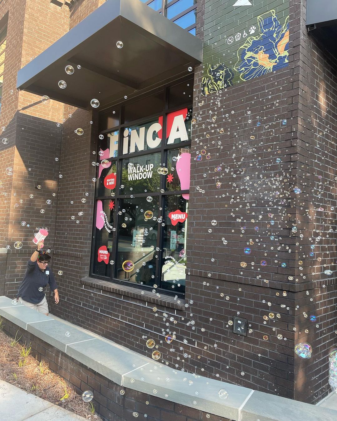 black building with pink designs on the window and lots of bubbles