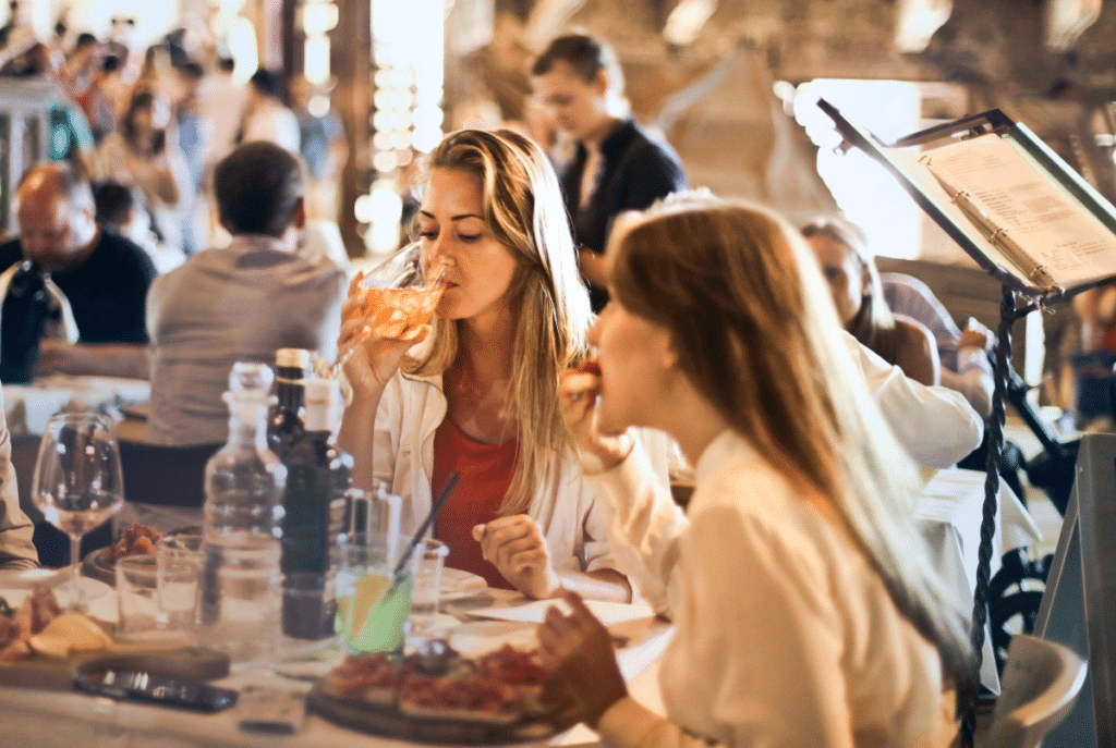 Two women dining out drinking wine at one of the many unique dining experiences in Atlanta