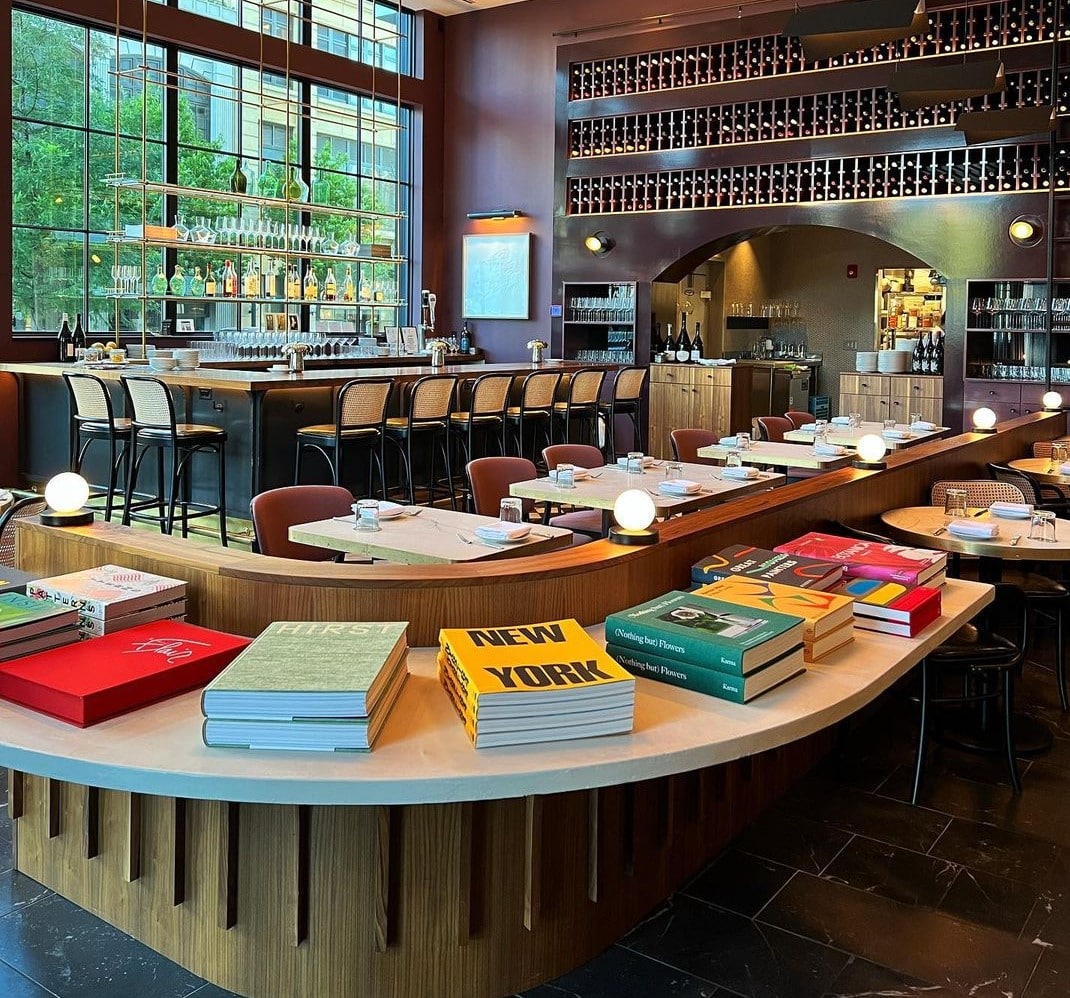 An image of the interior of Lucian Books & Wine capturing books on display and the counter seating.