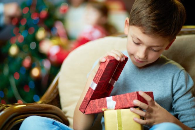 kid looking at presents on Christmas