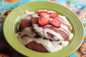 Chocolate pancakes drizzled with cream cheese and strawberries at Flying Biscuit