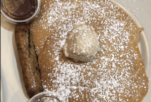 Pancake with powdered sugar and butter at Thumbs Up Diner