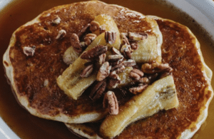 Pancakes topped with walnuts and bananas at Rias Bluebird