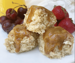 Biscuits smothered in caramel with a side of strawberries and cherries