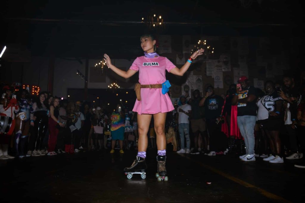 Trap x Sushi guest on roller skates in pink skirt and shirt
