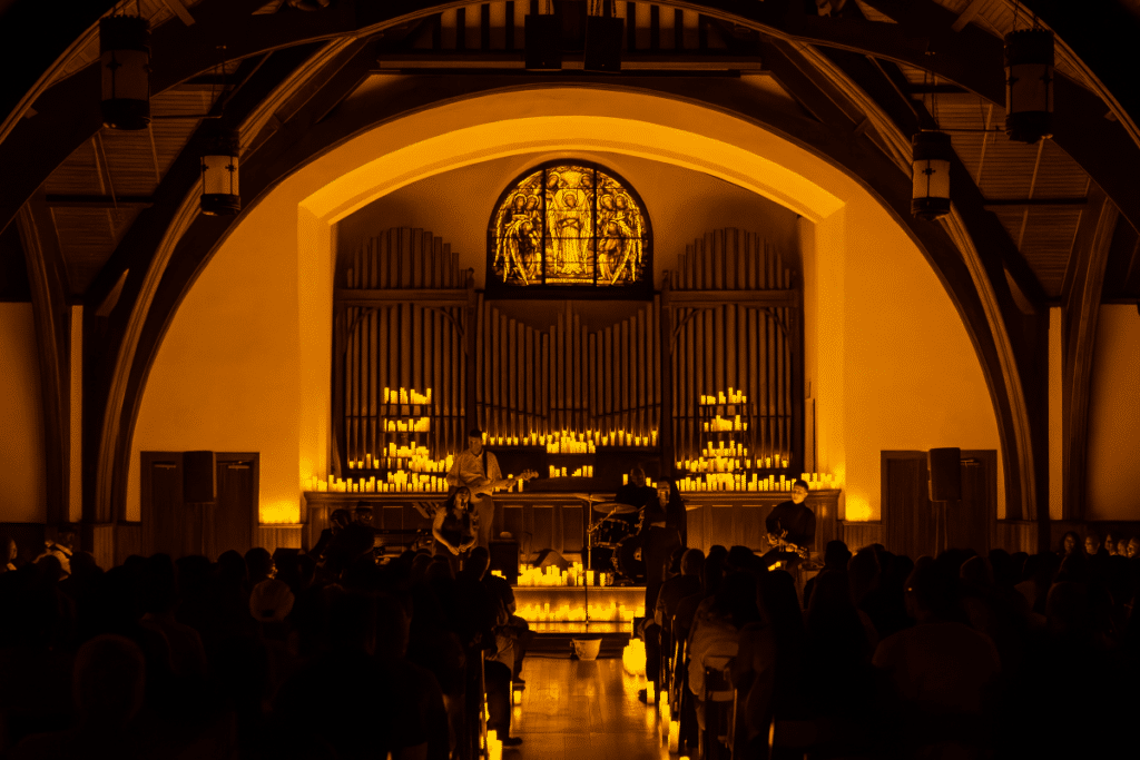 The altar inside The Chapel on Sycamore lit up by candles surrounded musicians performing a Candlelight concert.