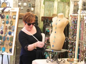 Festival-goer checking out a jewelry stall at the Artsapalooza