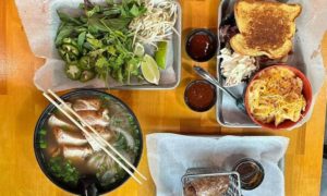A bowl of pho with other Vietnamese dishes at Pho Cue. 
