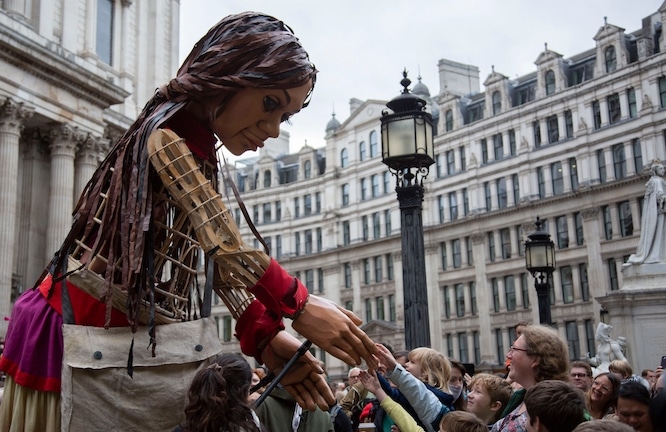 London OCT 23-2021: Little Amal, a giant puppet representing a Syrian refugee girl, arrives Saturday at St. Paul's Cathedral as part of an to raise awareness about the plight of millions of refugees.